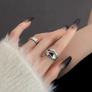 Detailed view of irregular geometric ring with black zircon stone on hand
