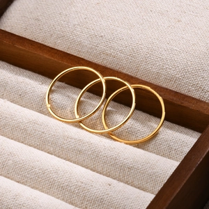Three-piece set of minimalist gold stainless steel rings with zircon on wooden box