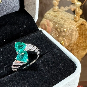 Macro view of luxury snake texture silver ring with triangular green zircons
