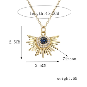 Detail view of gold Evil Eye pendant with blue zircon stones and size specifications
