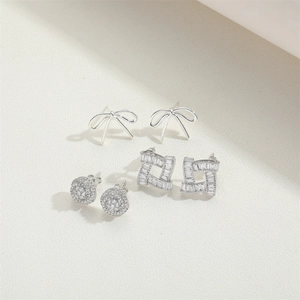 Silver bow and rhinestone stud earrings set in minimalist geometric designs