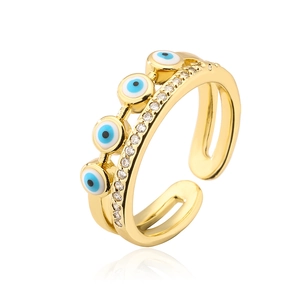 Close-up of golden evil eye ring with blue enamel eyes and pavé-set cubic zirconia detail