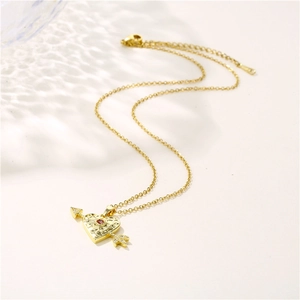 18K gold heart and arrow necklace with red zircon gemstone on a delicate chain