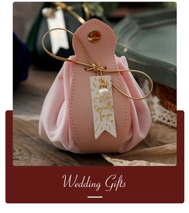 Pink velvet wedding favor bag with leather closure and decorative pearl pendant detail