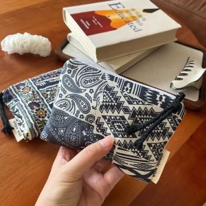 Detail of bohemian linen coin purses with paisley patterns and woven zipper pulls