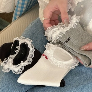 Close-up of sweet ruffled lace trim and embroidered detail on comfortable cotton socks
