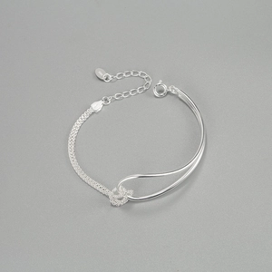 Detail of 925 sterling silver knot bracelet showing mesh chain and S925 hallmark tag