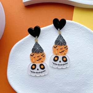 Detail view of Halloween acrylic earrings featuring pumpkin, skull, and spider web design