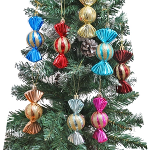Colorful electroplated candy ornaments with glitter stripes hanging on a green Christmas tree
