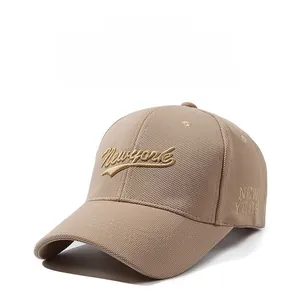 Detail of khaki baseball cap with golden New York embroidery and classic curved brim