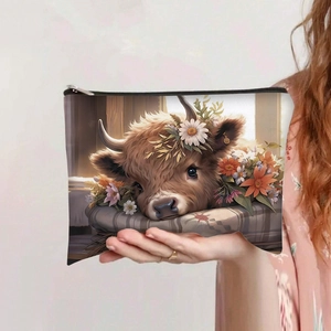 Detail of canvas makeup bag with highland cow print and a sturdy black zipper closure