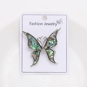 Detail of butterfly brooch with natural abalone shell wings and sparkling rhinestones