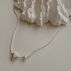 925 sterling silver snake chain necklace featuring a minimalist heart and bead pendant