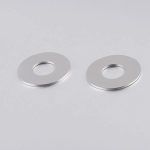 Macro shot of mirror-polished stainless steel round pendants with smooth hollow centers