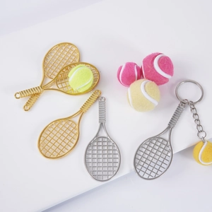 Miniature tennis racket and ball keychain set in metallic finishes and vibrant colors
