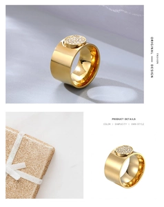 Detailed close-up of wide gold ring with micro-set zircon and festive gift box
