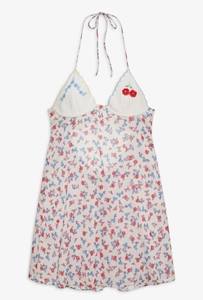 Detail shot of halter neck dress featuring red cherry embroidery and floral prints