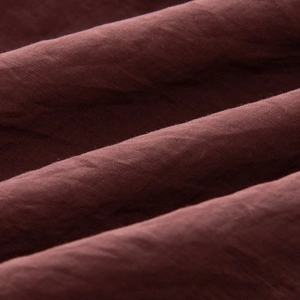 Macro shot of dark burgundy fabric showing premium texture and fine woven grain details