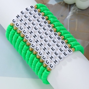 Detailed macro of green clay bead bracelets with CHEER letters and gold accents