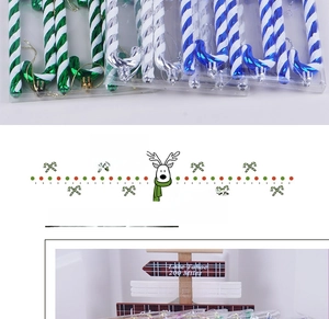 Close-up of glittery striped candy cane ornaments in green, blue and silver colors