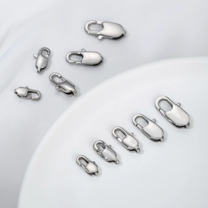 Macro view of polished stainless steel lobster clasps in various sizes for DIY jewelry
