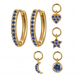 Detail of gold hoop earrings set with interchangeable moon, star, and heart charms