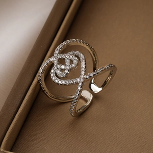 Hollow geometric open silver ring with sparkling heart cross design and small diamonds