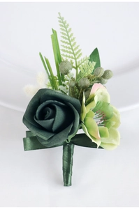 Detailed view of dark green PE rose boutonniere with decorative berries and leaves