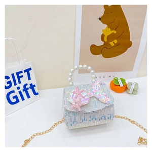 Detail of girls' sequin bag with pearl handle, iridescent fish tail and star charms