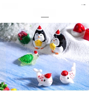 Miniature Christmas resin figurines of penguins and sea animals on faux snow