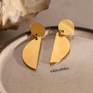 Golden brushed metal geometric earrings featuring circular and semicircular drop design