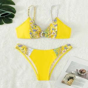 Floral print bikini set in bright yellow with metal ring detail for beach vacation