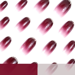 Glossy gradient burgundy press-on nails with silver glitter tips in oval shape