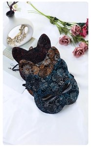Detailed trio of cat-shaped masquerade masks with glitter floral patterns in red, gold, blue
