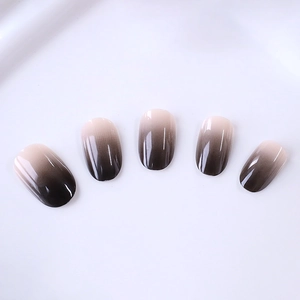 Elegant black gradient oval press-on nails with a high-gloss finish on a white background