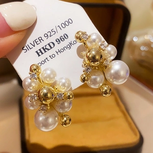 Detail of vintage bow pearl earrings with 925 silver hallmark and gold finish