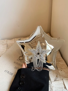 Detail of silver star-shaped acrylic clutch bag with sparkling rhinestone fringe tassels