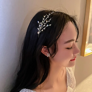Macro detail of silver branch headband featuring sparkling crystals and leaf patterns