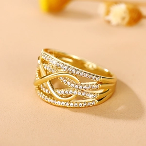 Detail of gold-plated hollow infinity ring with four rows of micro-pave diamonds