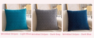 Detailed view of crushed velvet pillow covers in light blue, dark grey, and dark blue