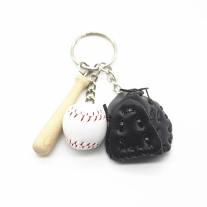 Detailed close-up of baseball keychain with wooden bat, white ball and black leather glove