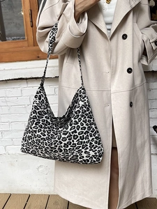 Stylish large capacity leopard print canvas tote bag carried by a model outdoors