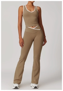 Detail view of high-waist flared yoga pants and racerback top with white piping accents