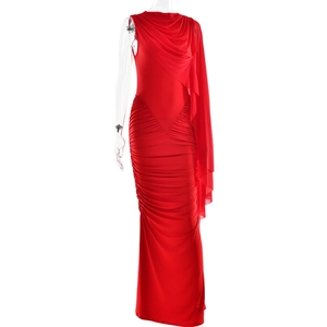 Detail of red ruched mesh evening gown featuring an elegant draped one-shoulder design