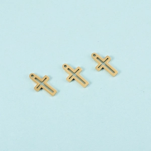 Detailed close-up of three golden hollow cross pendants for DIY jewelry making