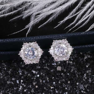 Macro detail of hexagonal halo stud earrings with clear zircon stones on jewelry box