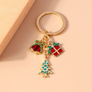Detail of Christmas keychain with gold bell, red gift box, and green tree charms