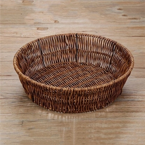 Detailed view of the intricate weaving and dark brown texture of the round storage basket