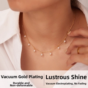 Macro view of dainty gold-plated necklace with small white pearls on a minimalist chain
