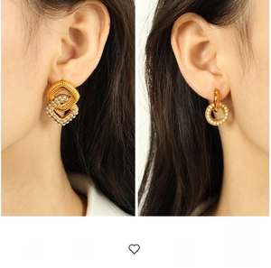 Detail shot of golden geometric earrings featuring twisted textures and inlaid crystals